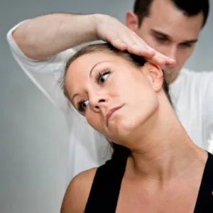 Chiropractor Performing A Gentle Stretch On Patient
