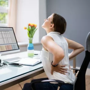 Back pain felt from patient who is spending too much time at her desk