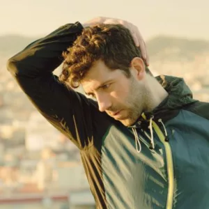 Man in San Francisco gently stretching his neck while exercising outdoors, embodying Rincon Chiropractic's approach to wellness.